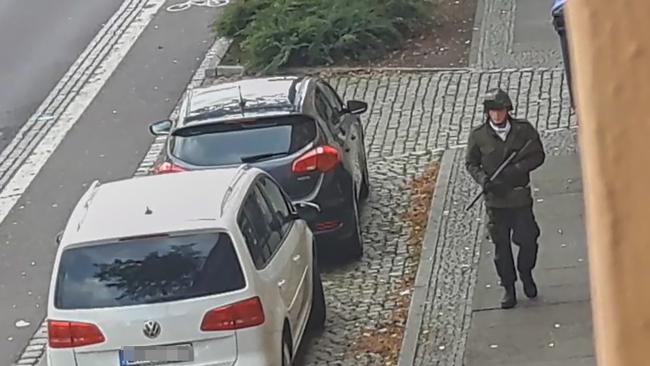 A man walks with a gun in the streets of Halle an der Saale, eastern Germany, on October 9, after at least two people were shot dead on a street. Picture: Andreas Splett / ATV-Studio Halle / AFP