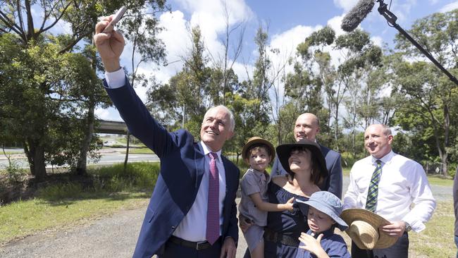 Malcolm Turnbull in Brisbane with three locals, and Luke Howarth, right, and Peter Dutton from the neighbouring electorate of Dickson, back. Picture: AAP