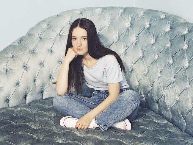 Norwegian singer Sigrid, on a siver couch