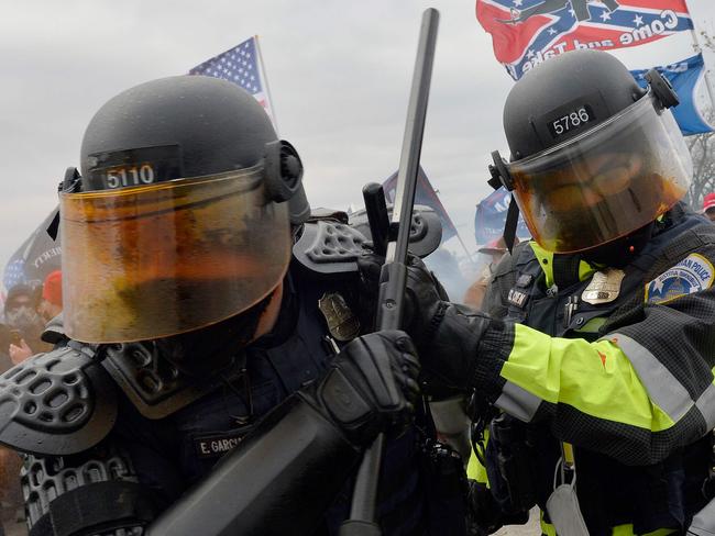 TOPSHOT - Trump supporters clash with police and security forces as they try to storm the US Capitol in Washington, DC on January 6, 2021. - Demonstrators breeched security and entered the Capitol as Congress debated the a 2020 presidential election Electoral Vote Certification. (Photo by Joseph Prezioso / AFP)