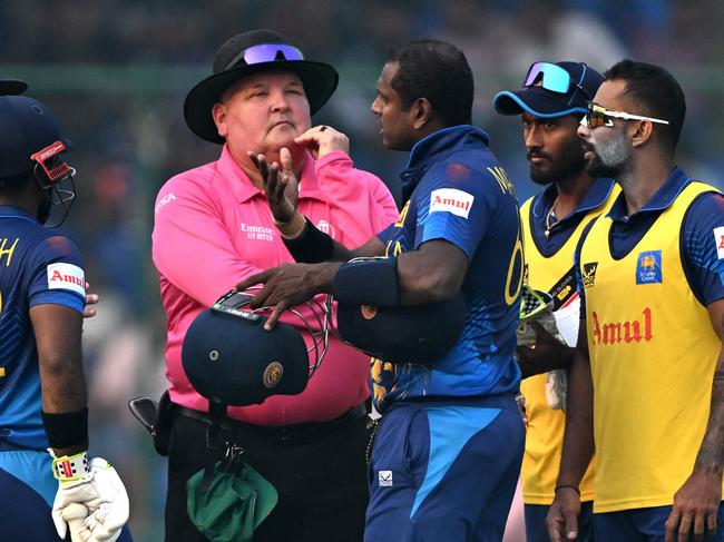 Sri Lanka's Angelo Mathews (3R) speaks with the umpires after he was timed out during the 2023 ICC Men's Cricket World Cup one-day international (ODI) match between Bangladesh and Sri Lanka at the Arun Jaitley Stadium in New Delhi on November 6, 2023. (Photo by Arun SANKAR / AFP) / -- IMAGE RESTRICTED TO EDITORIAL USE - STRICTLY NO COMMERCIAL USE --