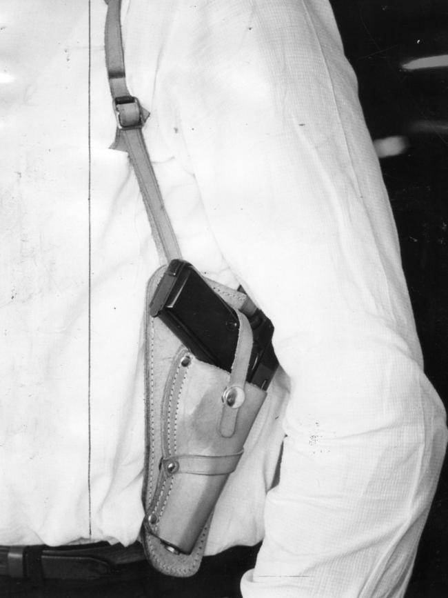 1965: A South Australian detective wears an armpit holster with a .38 Browning automatic pistol. Picture: Sam Cheshire/File