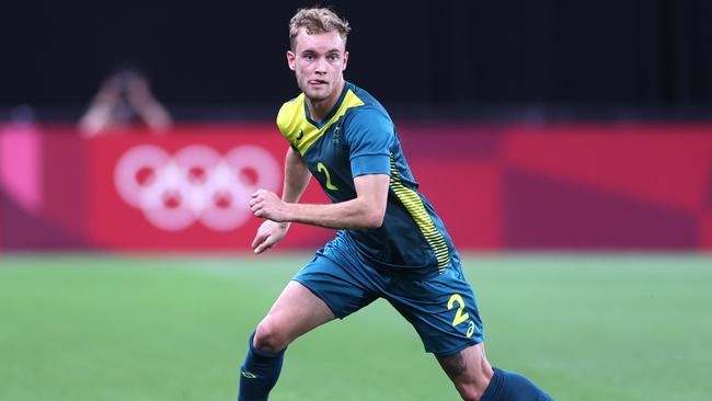 SAPPORO, JAPAN - JULY 22: Nathaniel Atkinson #2 of Team Australia on the ball during the Men's First Round Group C match between Argentina and Australia during the Tokyo 2020 Olympic Games at Sapporo Dome on July 22, 2021 in Sapporo, Hokkaido, Japan. (Photo by Masashi Hara/Getty Images)