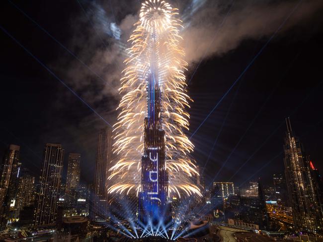 This photograph shows fireworks exploding around the Burj Khalifa Tower during New Year's celebrations in Dubai on January 1, 2025. (Photo by FADEL SENNA / AFP)