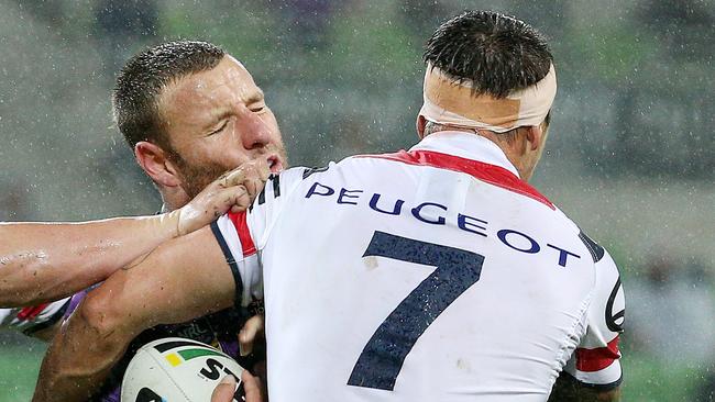 Blake Green is tackled by Mitchell Pearce.