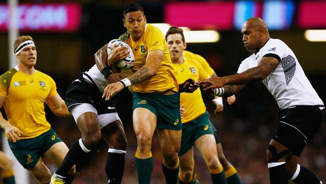 CARDIFF, WALES - SEPTEMBER 23: Israel Folau of Australia makes a break during the 2015 Rugby World Cup Pool A match between Australia and Fiji at the Millennium Stadium on September 23, 2015 in Cardiff, United Kingdom. (Photo by Laurence Griffiths/Getty Images)