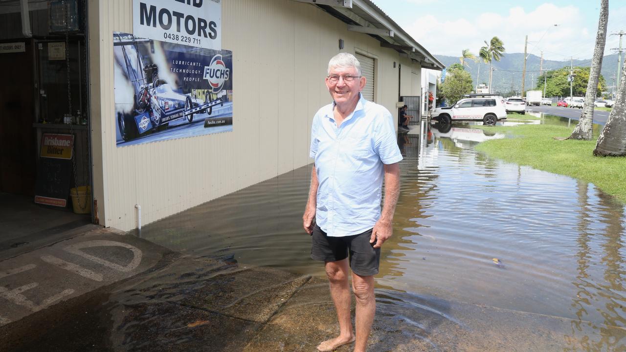 Graham Reid from Reid Motors on Hartley St stands in king tide water outside the workshop. Picture: Peter Carruthers