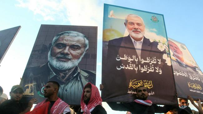 People take part in a march called by Palestinian and Lebanese youth organisations in the southern Lebanese city of Saida to protest against the assassination of Hamas chief Ismail Haniyeh (portrait) and a Hezbollah military commander. Picture: Mahmoud Zayyat/AFP