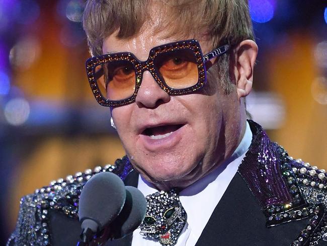 (FILES) In this file photo taken on January 31, 2018 Elton John addresses fans on stage during the "Elton John: I'm Still Standing - A GRAMMY Salute" concert at The Theater at Madison Square Garden in New York. Elton John has tearfully apologised to fans after cutting short a concert in New Zealand due to illness, with the British superstar saying he was suffering from "walking pneumonia" on February 17, 2020. (Photo by ANGELA WEISS / AFP)