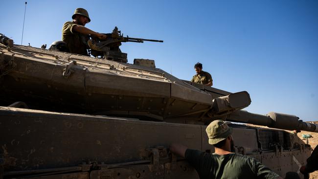 IDF soldiers clean parts of a tank in Southern Israel. Picture: Getty