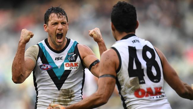 Travis Boak (left) and Lindsay Thomas of the Power react after Boak kicked a goal during the Round 15 win over Carlton. Picture: AAP Image/Julian Smith