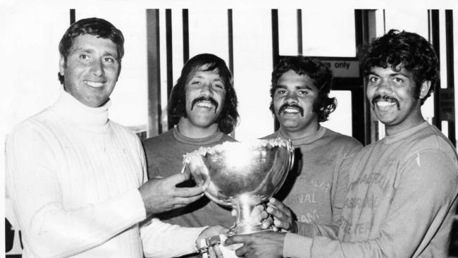 Joyful members of the successful SA Aboriginal football team at Adelaide Airport (l-r) coach Michael Wanganeen, Michael Graham, Wilbur Wilson and Eugene Warrior 06 Oct 1975.