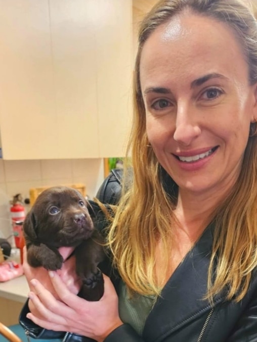 Game with her pet dog, chocolate labrador Emma. Picture: Supplied