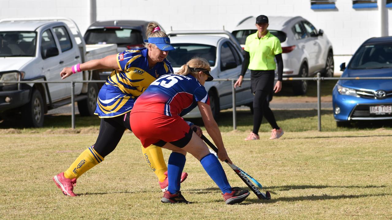 Warwick's Yas Van Kasteran and Townsville's Kirsty Reason fight for possession at the 2021 Queensland Hockey Women's Masters Championship at Queens Park.