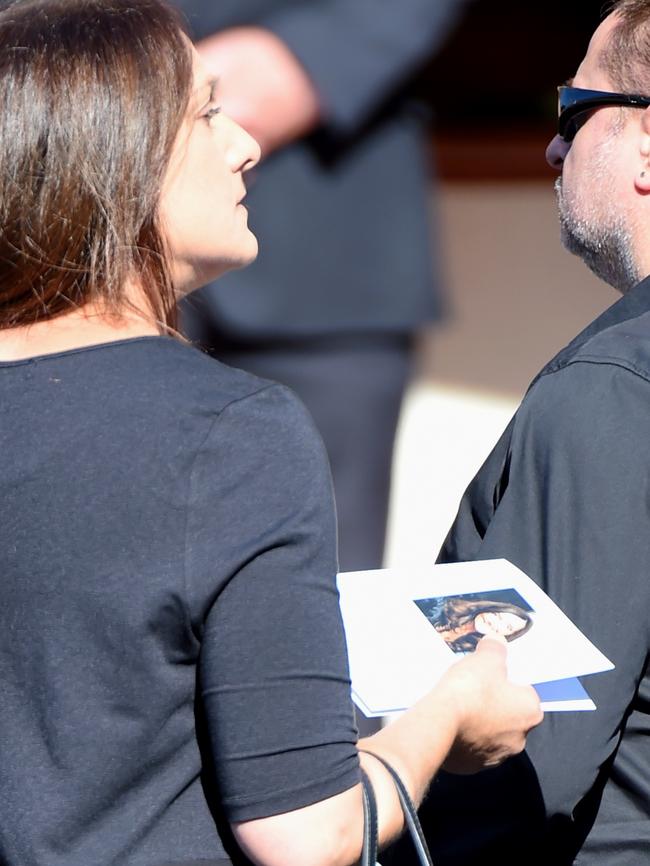 A mourner holds the order of service with a photo of Karen. Picture: Nicole Garmston