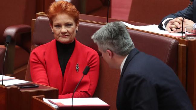 Senator Pauline Hanson talking with Senator Mathias Cormann. Picture: Kym Smith