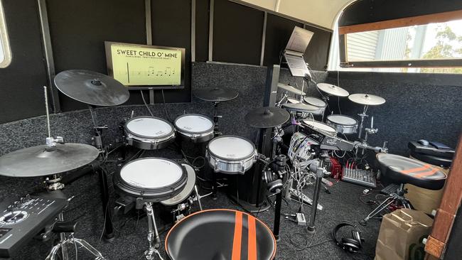 The set up includes two electric drum kits, two computer screens, a Bose speaker and more. Picture: Tom McGann.