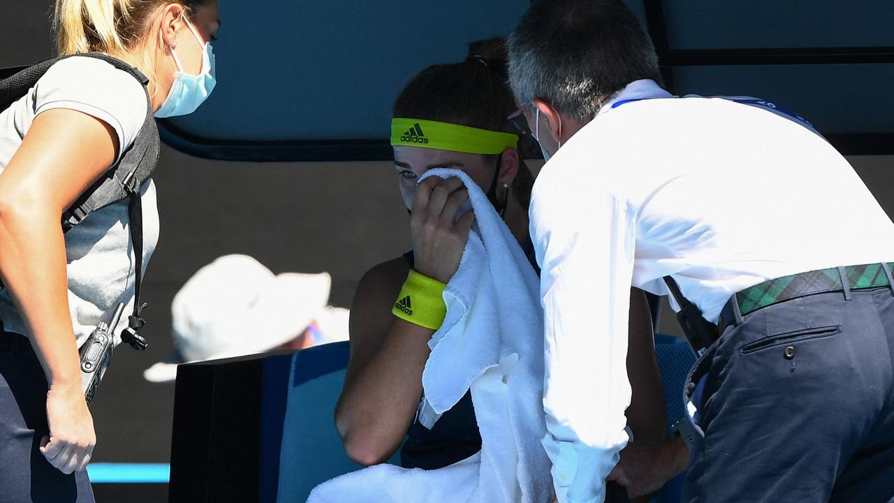 Czech Republic's Karolina Muchova (C) receives medical attention at a crucial juncture of her clash with Ash Barty.