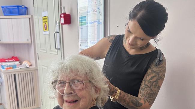 Mater Private Hospital Rockhampton patient Heather Orr receives a trim  from Thieves and Beggars hairdresser Kara Morgan.