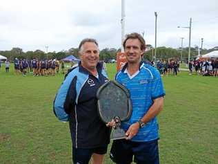 Ian Hooper known as 'Hoops' at the annual Byron 7's Rugby Carnival, presenting 'The Monkey' Trophy to Referee Matt Clayton. Picture: William Palmer