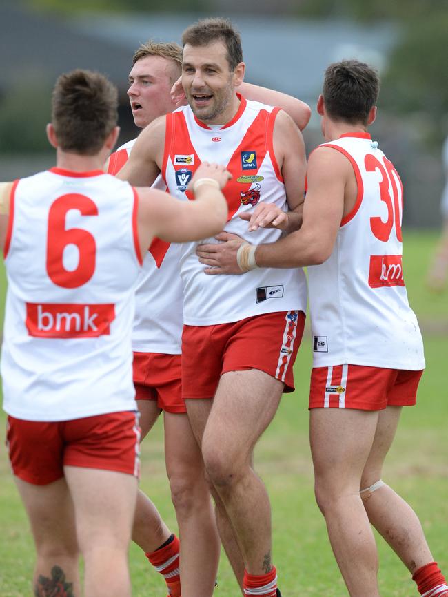 ...and is congratulated by Bulls teammates.