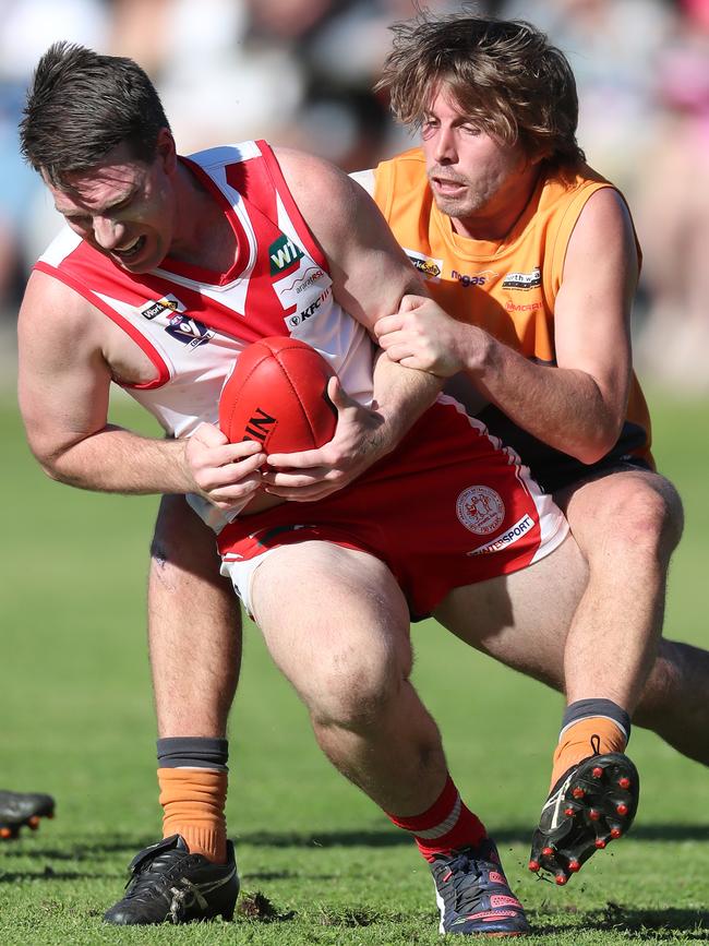 Giants player Billy Lloyd sticks a strong tackle on Ararat star Daniel Mendes.