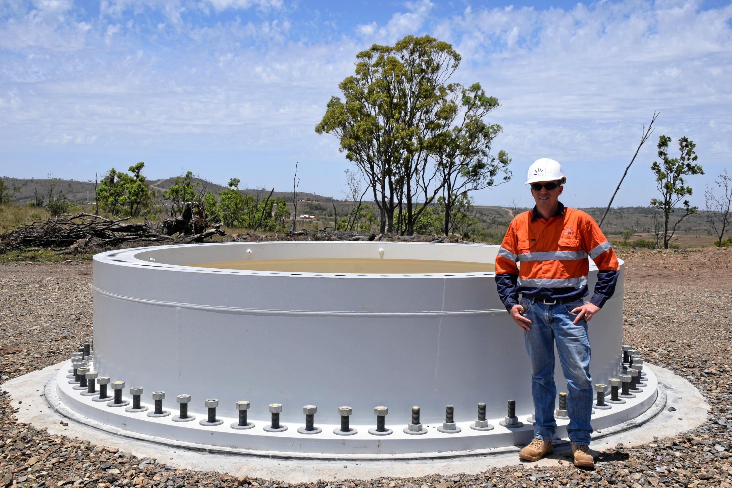 AGL's Client Site Representative, Michael Yeo next to a base of one of the 123 wind turbines. Picture: Matt Collins