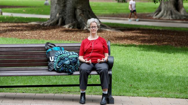 A woman meditates in Hyde Park, Sydney. Picture: Nikki Short