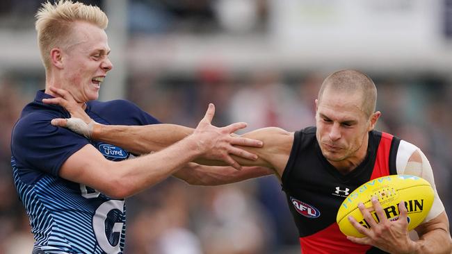 David Zaharakis fends off a tackle from Zach Guthrie during Monday’s clash.