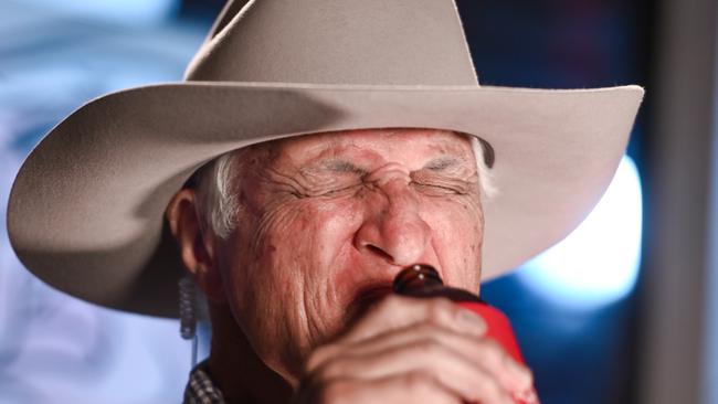 Bob Katter takes a drink during a live TV cross at Jam restaurant in Townsville. Picture: