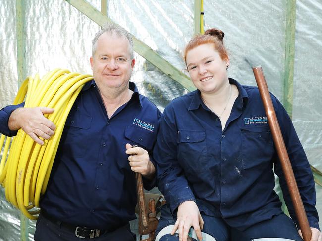 Plumber Colin Young and his apprentice Rebecca Harrison on a house construction site in Peakhurst. Picture: Rohan Kelly