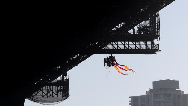 The trio abseiled off the bridge after 10 others were detained and arrested. Picture: Richard Dobson