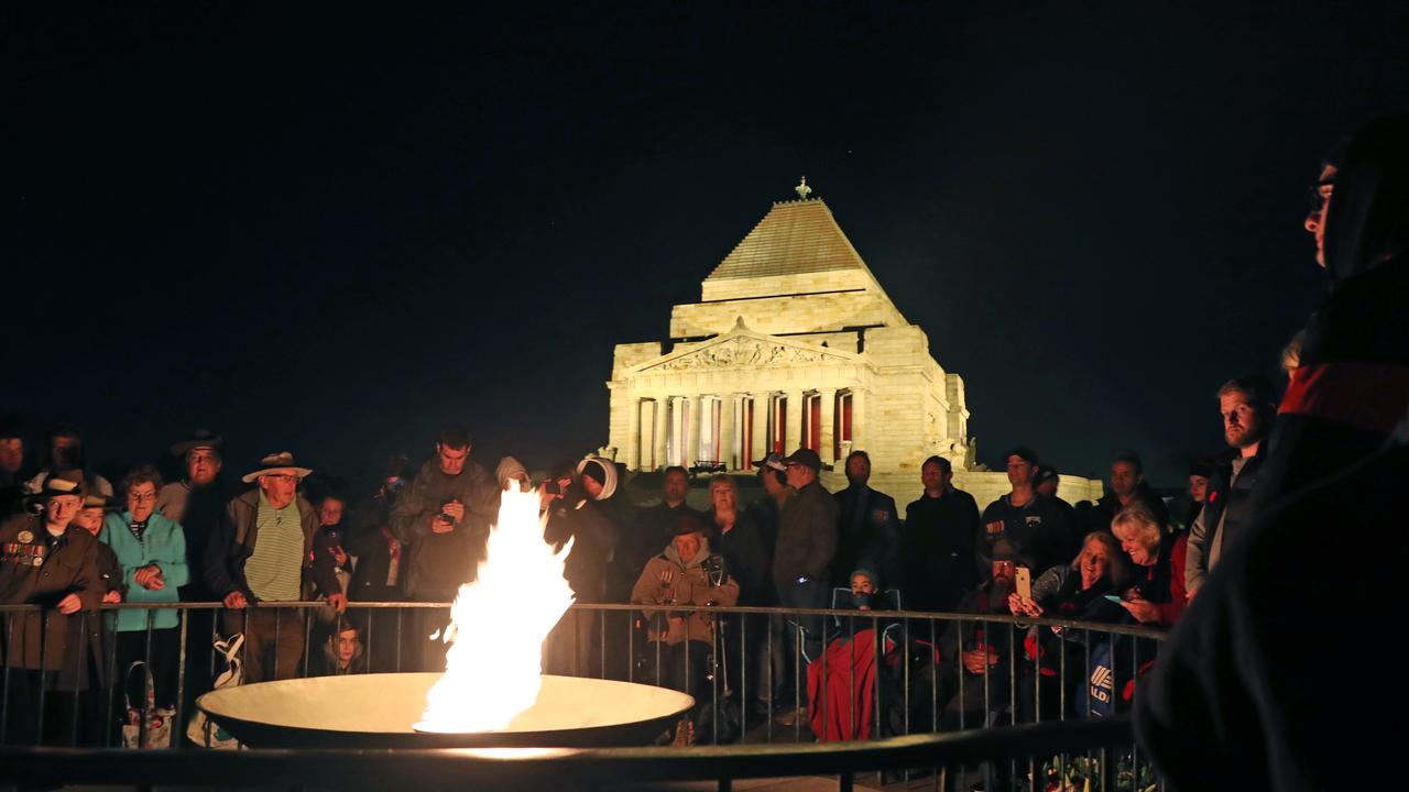 Crowds gather during the Anzac Day Dawn Service in front of the perpetual flame at the Shrine of Remembrance in Melbourne on April 25, 2019. Picture: AAP Image/David Crosling