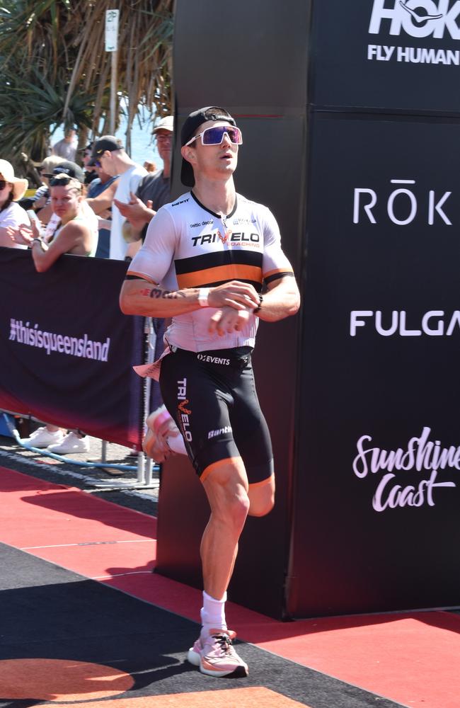 Athletes crossing the finish line at Sunshine Coast Ironman 70.3 2023.