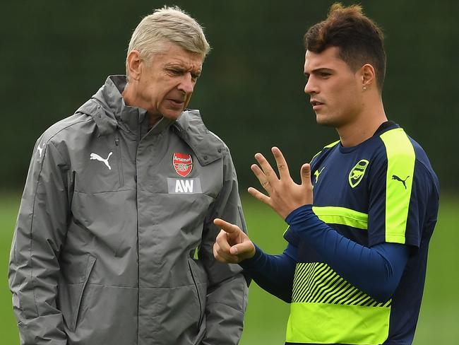 Arsene Wenger talks to Granit Xhaka.