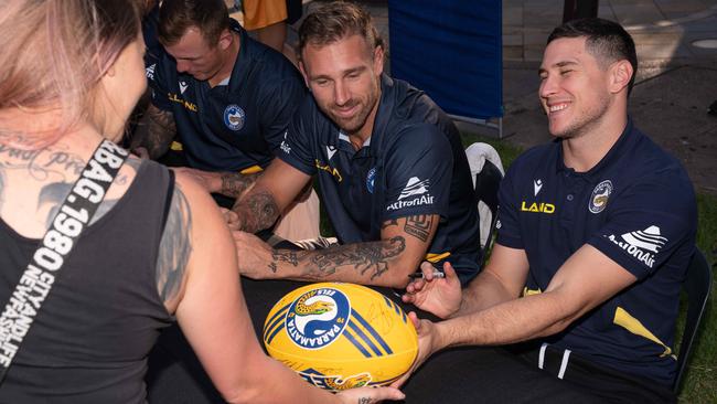 Eels players Bryce Cartwright and Mitchell Moses sign a ball for a fan on the Darwin Waterfront. Picture: Pema Tamang Pakhrin