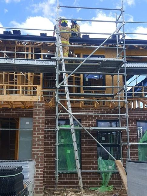 Firefighters rescue a man who feel asleep on the roof of a building in Oak Park.