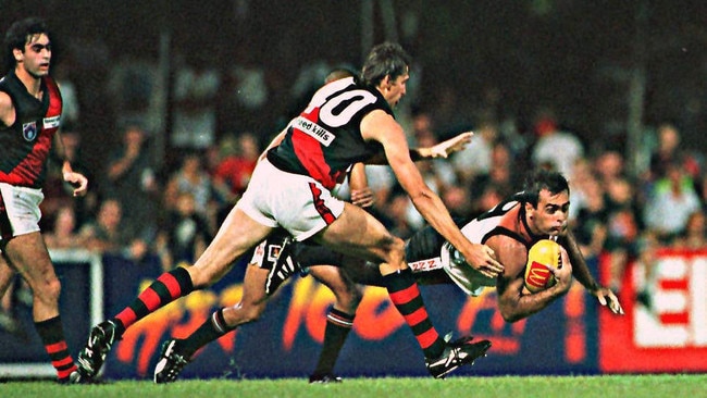 Russell Jeffrey looks to evade Essendon's Tim Williams ... Jeffrey was a linchpin when delivering the ball out of defence. Picture: Dani Gawlik