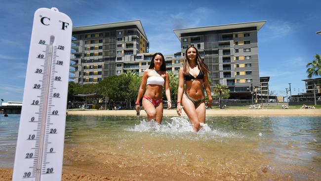 Chelsea and Jessica Menhenett, from Melbourne, enjoy the Darwin weather yesterday. Picture: Katrina Bridgeford