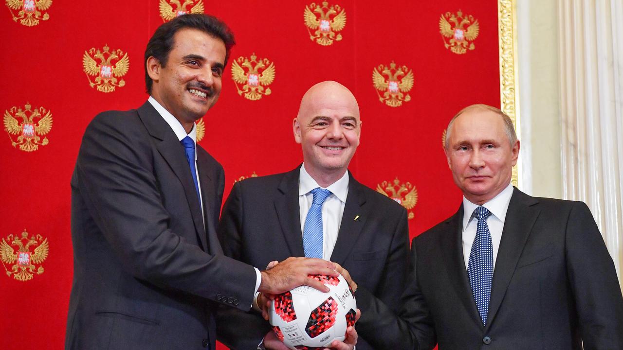 (From L) Emir of Qatar Sheikh Tamim bin Hamad Al-Thani, FIFA President Gianni Infantino and Russian President Vladimir Putin pose for a photograp