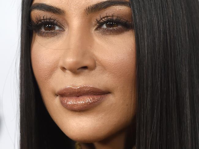 Kim climbs tree completely naked
