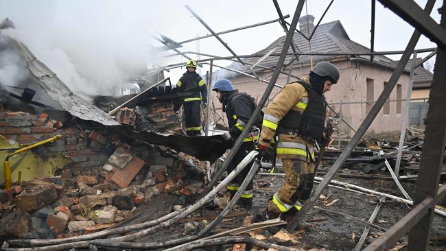 Rescuers of the State Emergency Service work to put out a fire in a private house after a drone strike in Kharkiv, on December 25. Picture: AFP