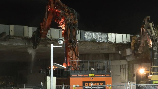 Two cranes removing concrete as old bridges are demolished as part of the $1 billion M1 upgrade from Varsity Lakes to Tugun.