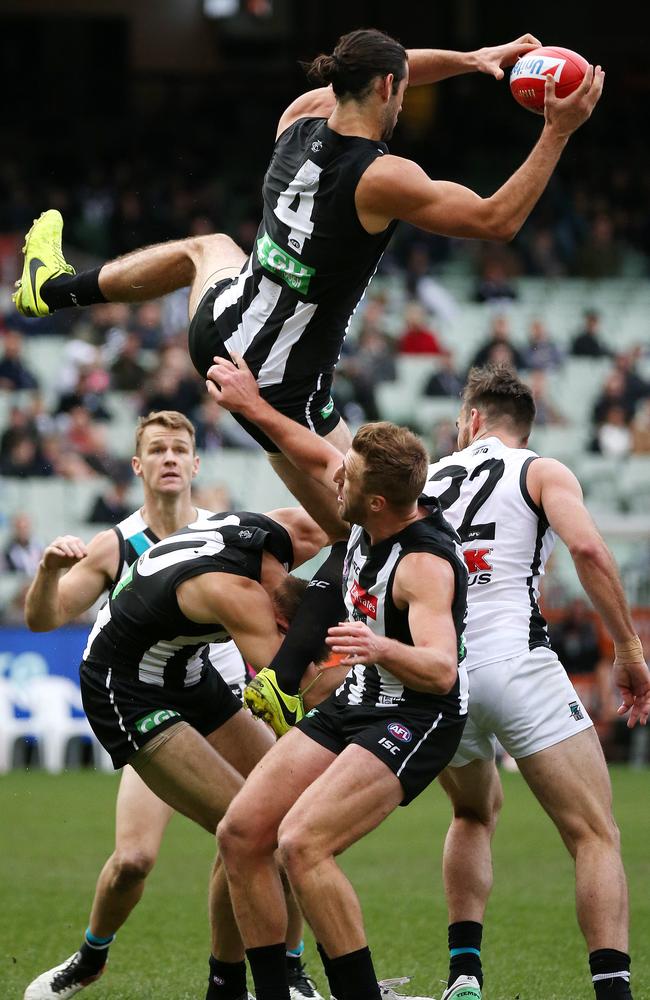 Brodie Grundy takes a hanger over teammate Darcy Moore. Picture: George Salpigtidis