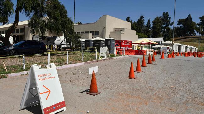 A Covid-19 vaccine site worker sits alone waiting for people at the Lincoln Park Covid-19 vaccine facility in Los Angeles, California. Picture: AFP