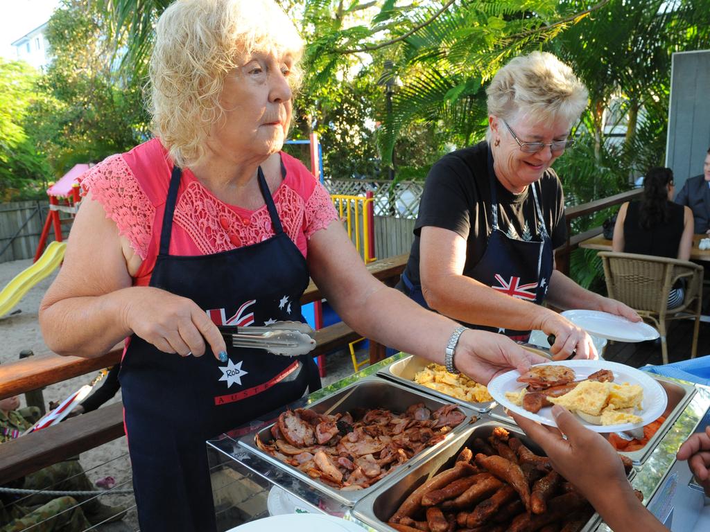 ANZAC DAY: Lorraine Mackey and Maureen Hall serve up breakfast at a previous Gunfire Breakfast after the Bargara Dawn Service. Photo: Mike Knott / NewsMail