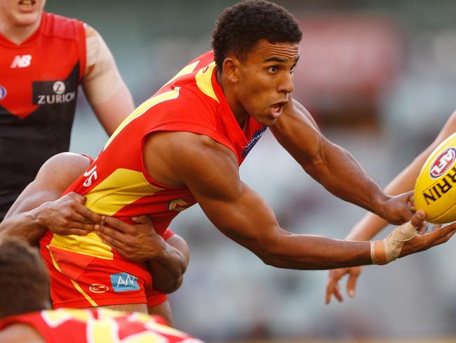 Touk Miller of the Suns handpasses the ball under pressure during the Round 20 AFL match between the Melbourne Demons and the Gold Coast Suns at the MCG in Melbourne, Sunday, August 5, 2018. Picture: AAP Image/Daniel Pockett.