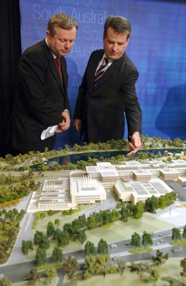 Former premier Mike Rann and ex-treasurer Kevin Foley hover over a model of the new RAH.