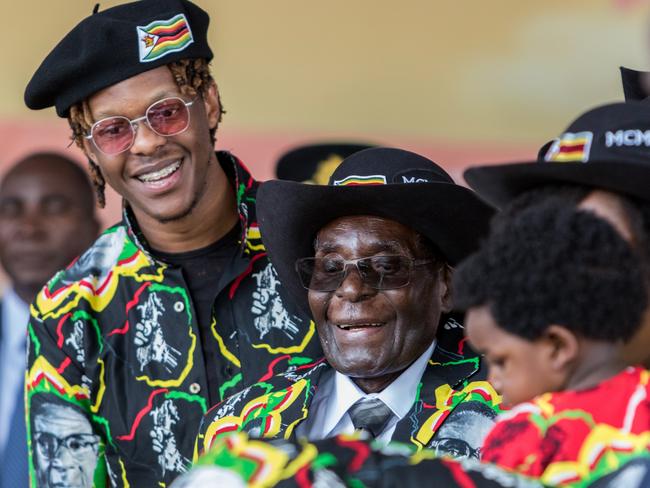 Robert Mugabe with his son Robert Jr, and his grandson during his 93rd birthday celebrations in February. Picture: Jekesai Njikizana/AFP