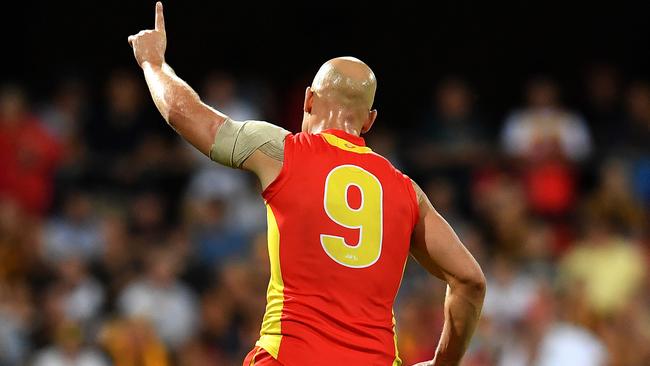 Gary Ablett celebrates a goal against Hawthorn.